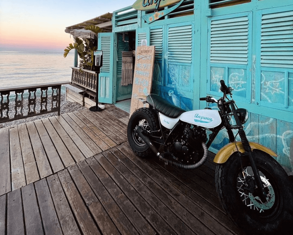 people love taking photos with anjuna's vintage motorcycle